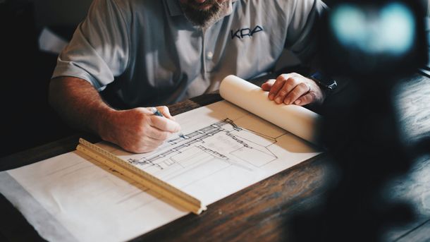 Builder reviewing project drawings