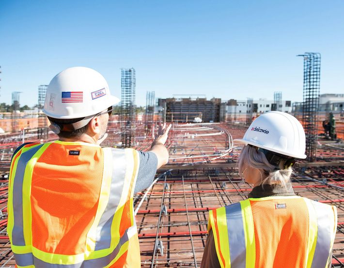 Clients and builder discussing a construction site
